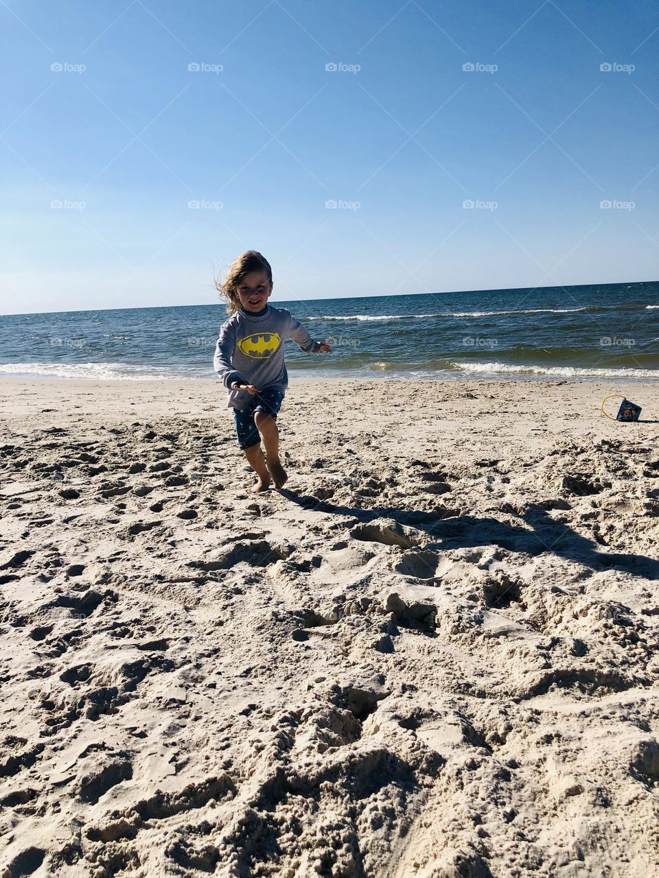 Boy running on the beach 