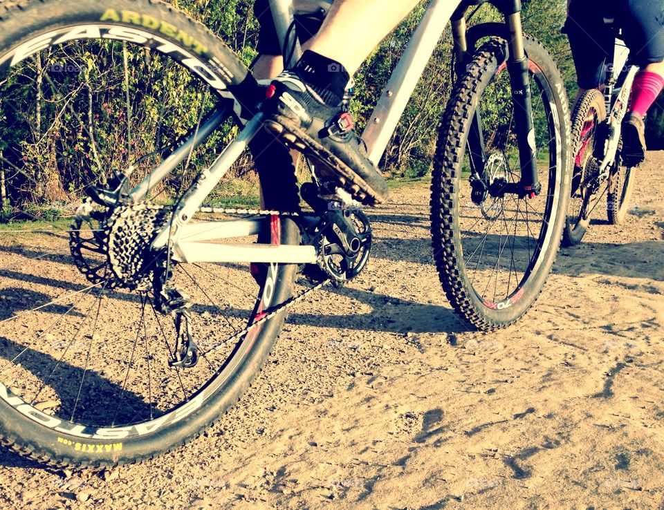 Evening mountain bike ride. Two mountain bikers riding by on the trail 