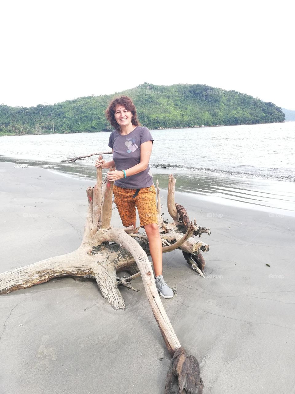 woman and death wood tree in the beach