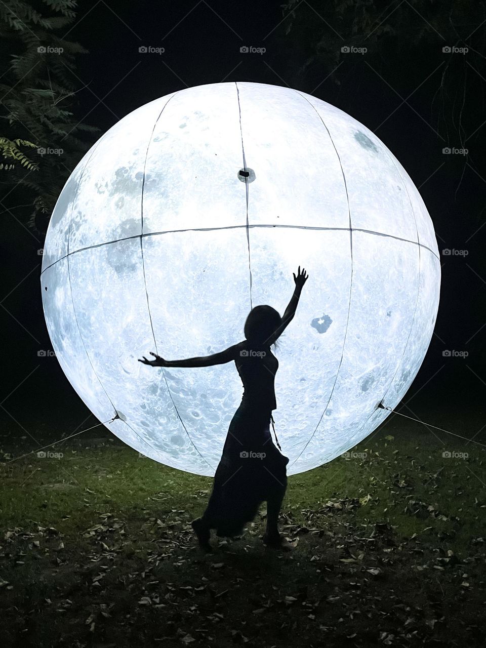 Woman Dancing in Front of the Art Installation Moon