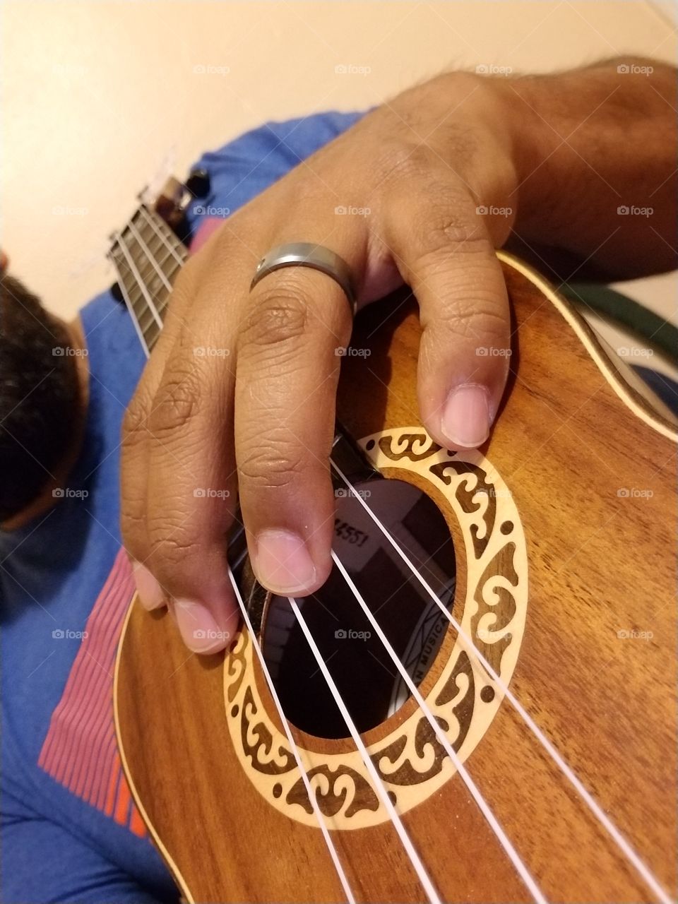 holding an ukulele