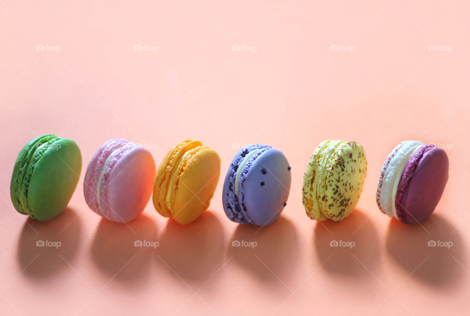 Colorful macaroons desserts in a row