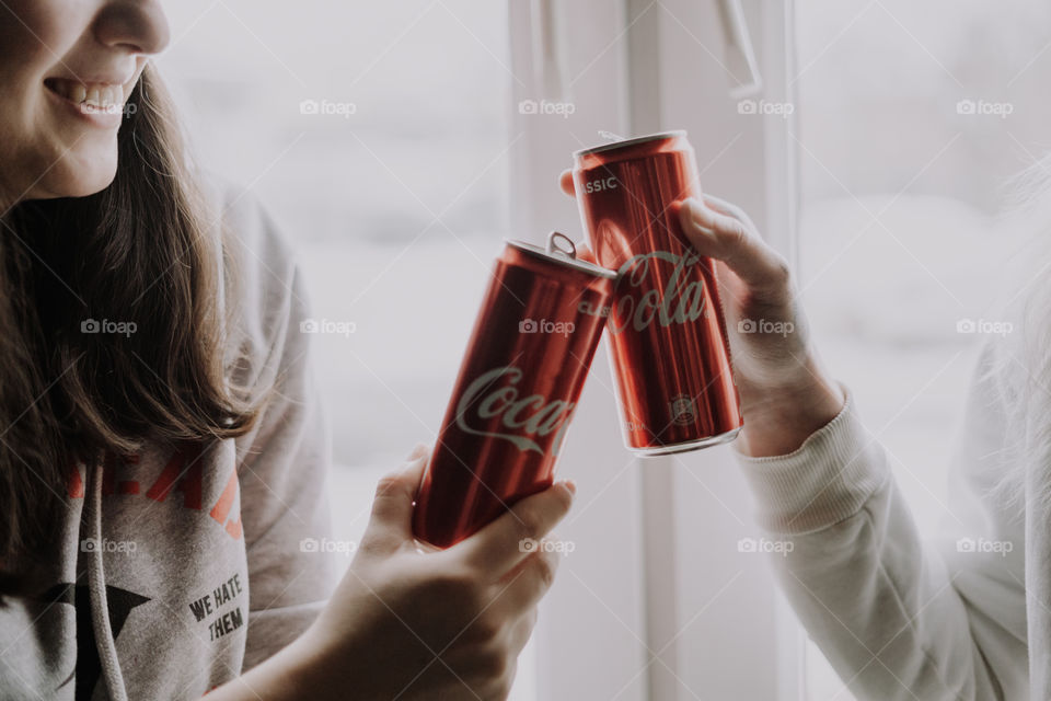 coca cola in hands / cheers with coca cola