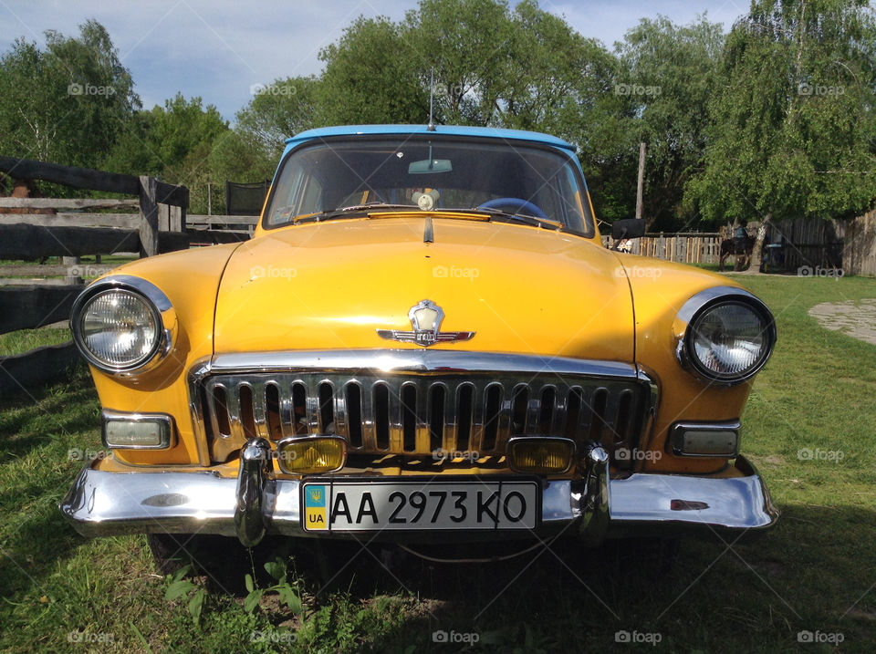 Yellow old car on a yard