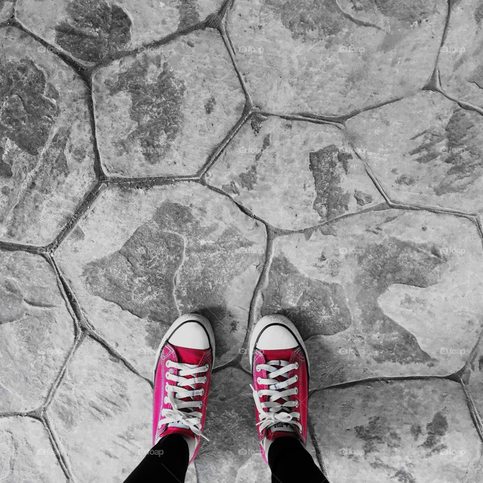 Red Sneakers Shoes Walking On Dirty Concrete Top View , Canvas Shoes Walking On Concrete Great For Any Use.