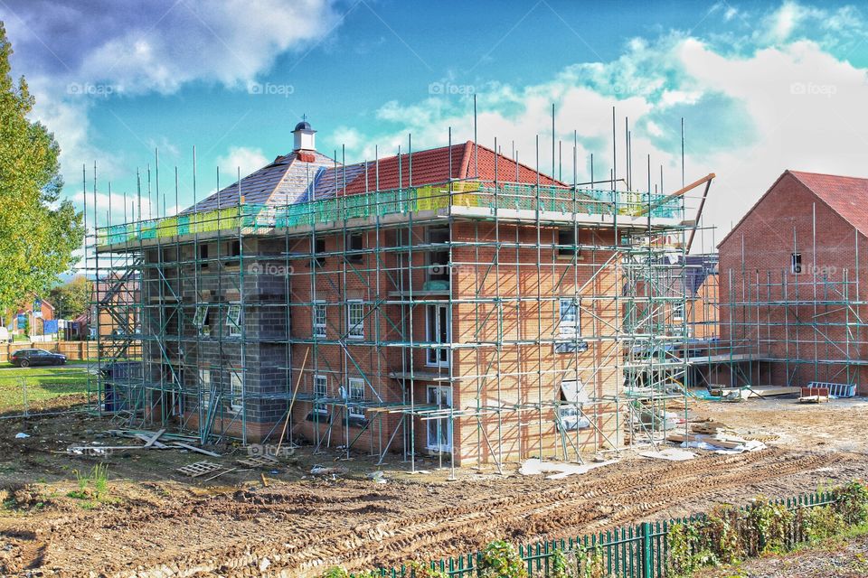 New Home Construction Site. A newly built home surrounded by scaffold.