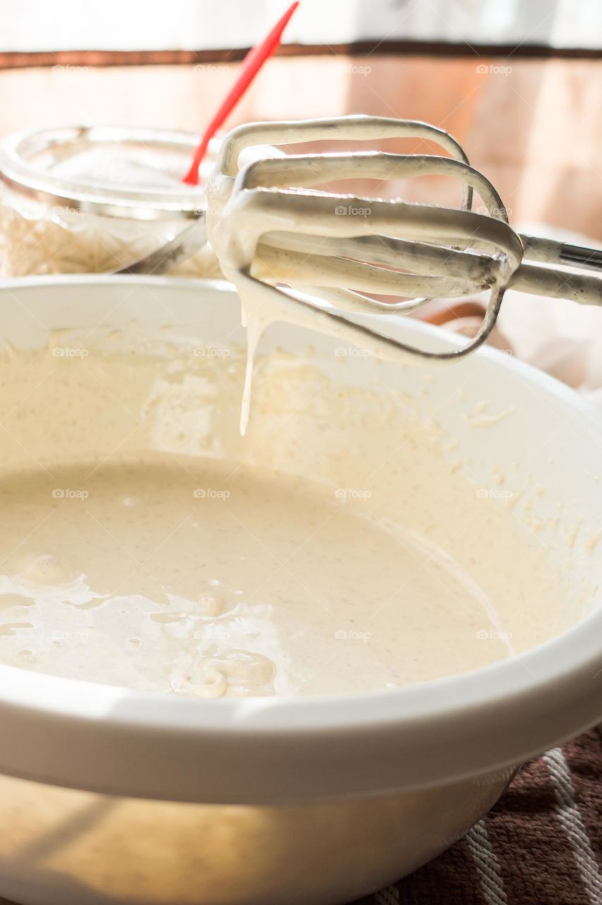 Making an apple pie dough using eggs, flour, sugar and apples.