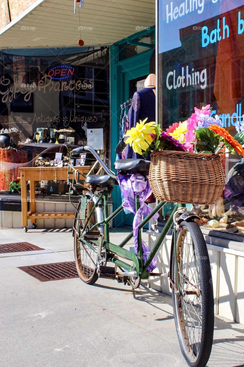 Tandem bike outside of a quaint small town shop