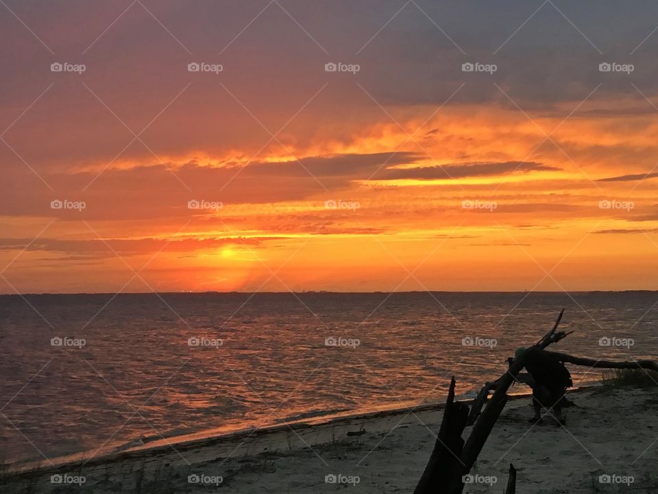 
Sitting on the beach watching the big orange ball slowly going down and down and it sets into the horizon making the  sky absolutely stunning. Magnificent!