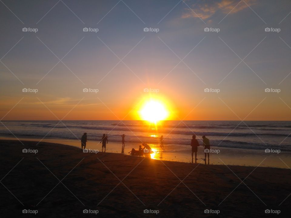 Silhouette of people at beach during sunset