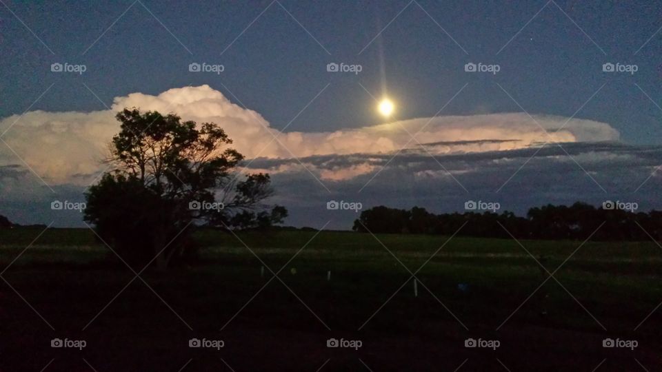 moon shining over storm clouds