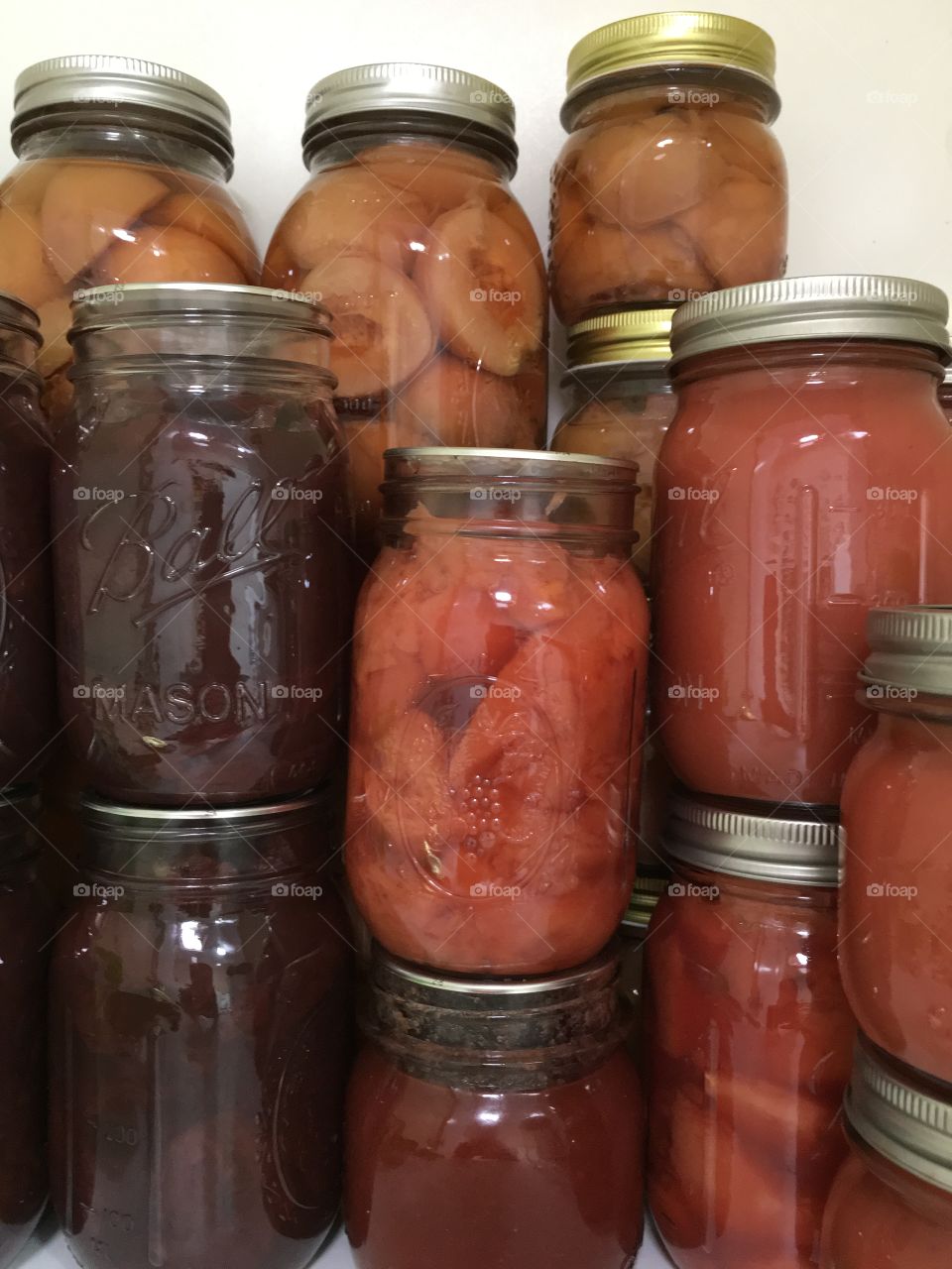 Pantry filled with home preserves in mason jars 