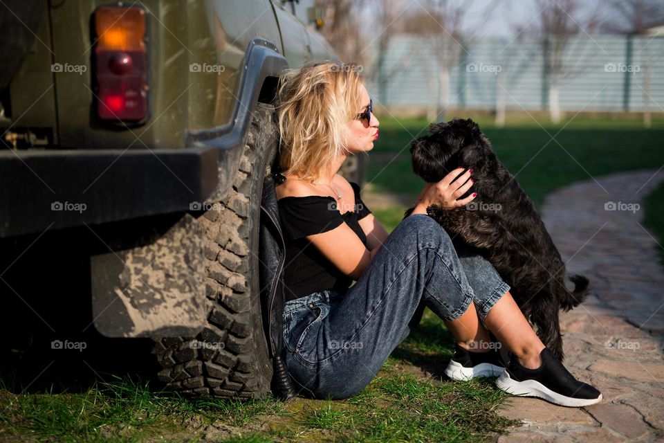 walking the dog down the street, the owner walks the weakling, teaches her, cleans up after her, educates, plays with his pet. people and dogs are best friends