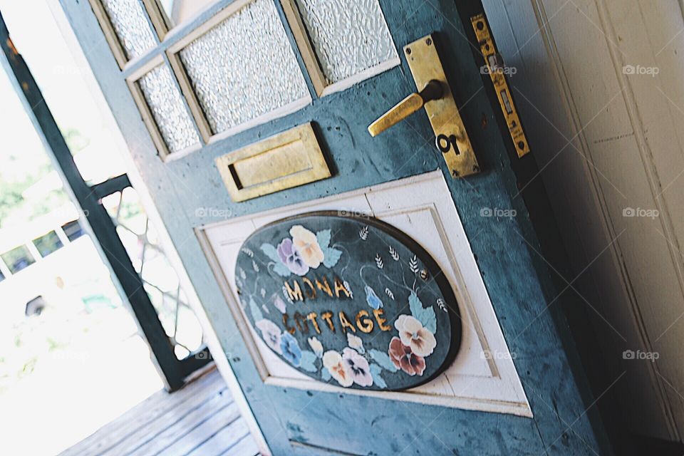 Blue open door with pretty painting and text