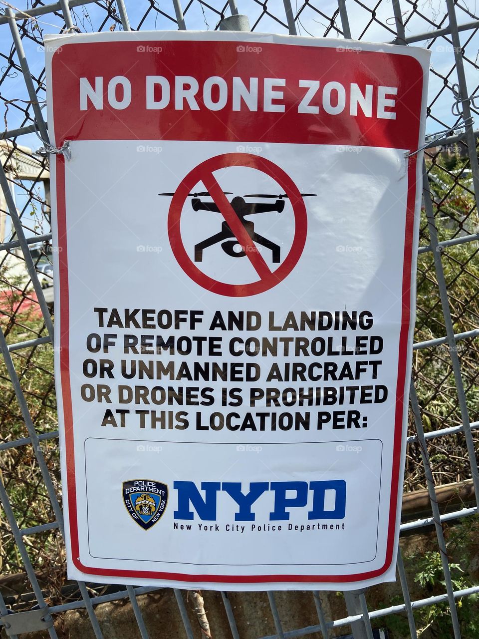 “Takeoff and landing of remote controlled or unmanned aircraft or drones is prohibited at this location per: NYPD”. The sign stuck to a fence in “Newtown Creek” in LIC, Queens says it all. 2021. Hypnotic Productions