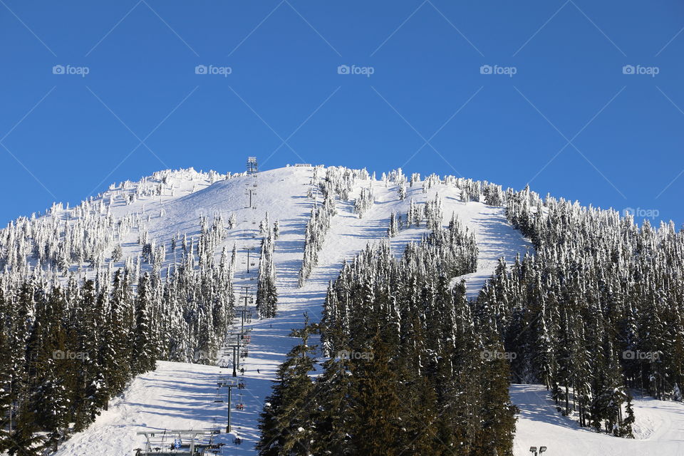 Mountain covered with snow and trimmed slopes for skiing 