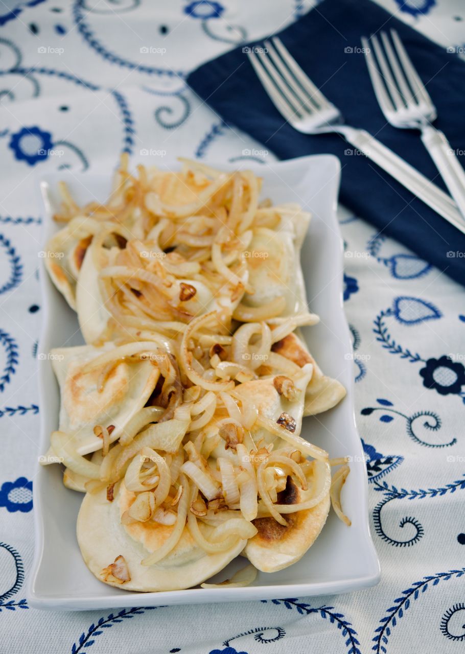 Polish potato pierogis with sautéed onions 