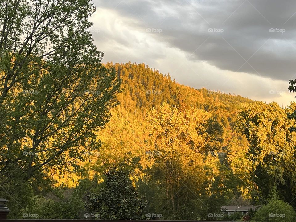 Sunset shines on mountains in the West. 