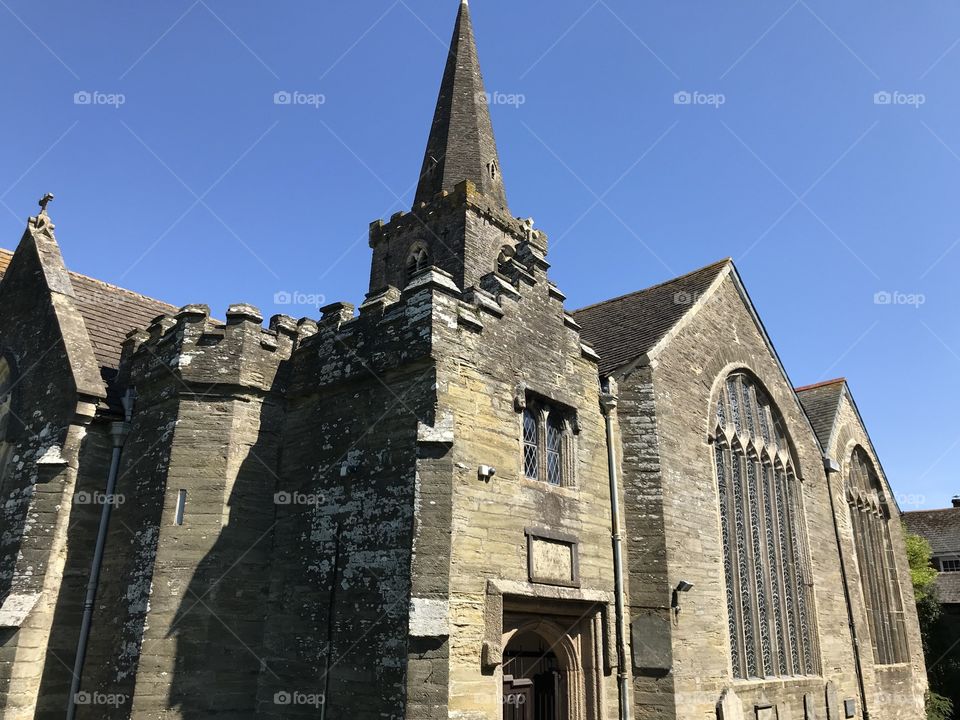 St Edmunds Church in Kingsbridge captured in deep blue spring sunshine, highlighting its presence.