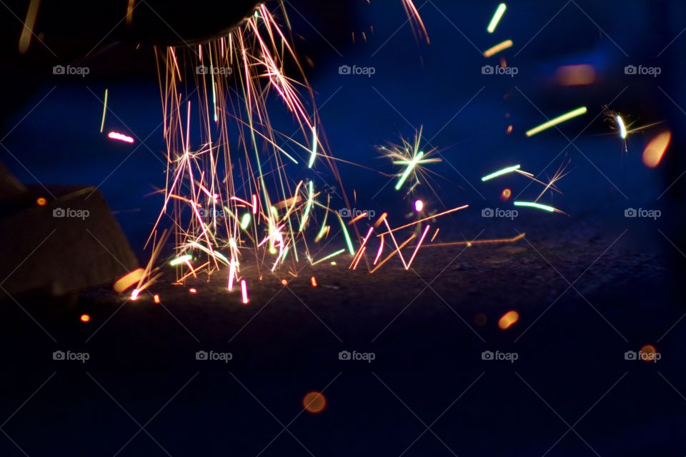 Closeup of sparks from a bench grinder being used on steel