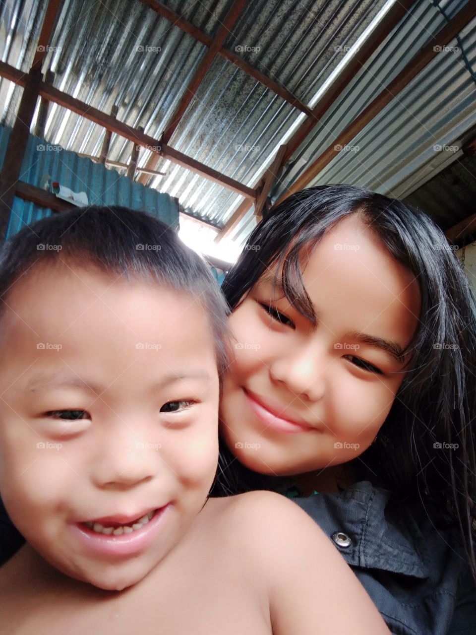 Two loving faces of a sister and her younger brother of the same parent at Langjing Achouba Makha Leikai, Imphal, Manipur, a state in India.