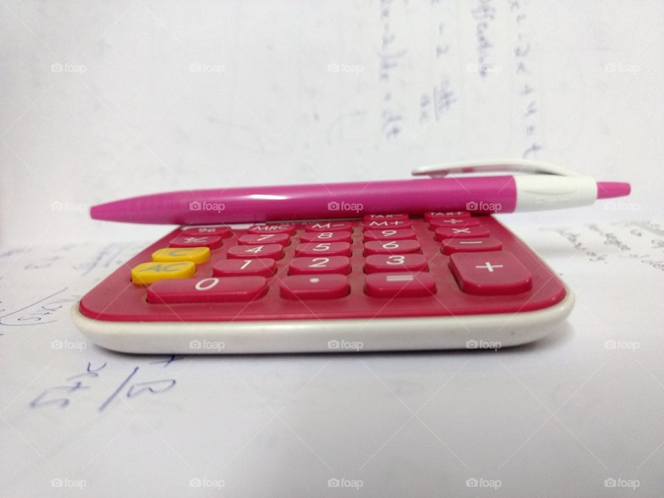 Pink calculator and pen.