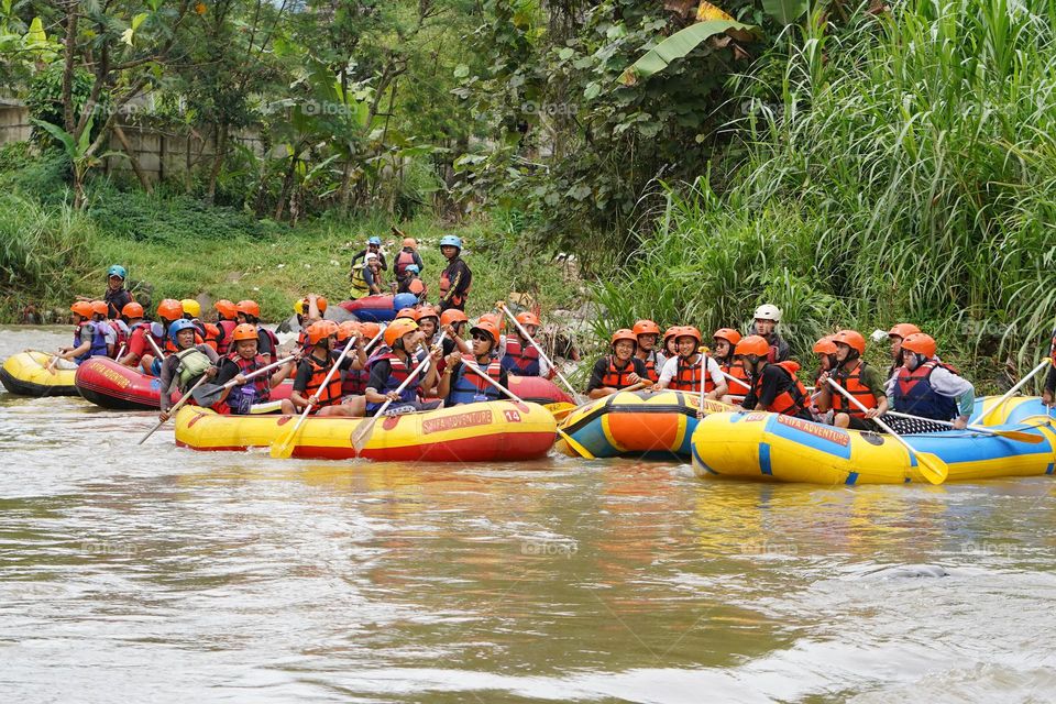 people on inflatable boats in the river 