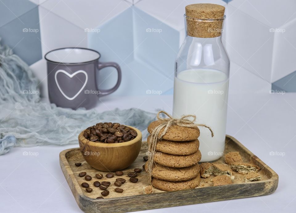 Oatmeal cookies and milk in a bright kitchen