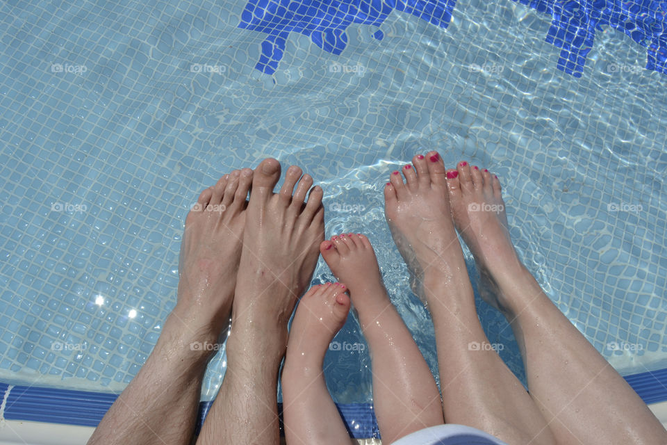 Family playing in the pool with their feets  at their family holiday in Turkey.