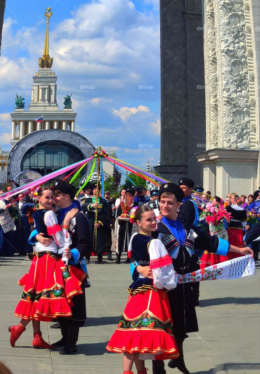 National dance of the Cossacks. Girls and men in national costumes. Round dance.Multinational Russia