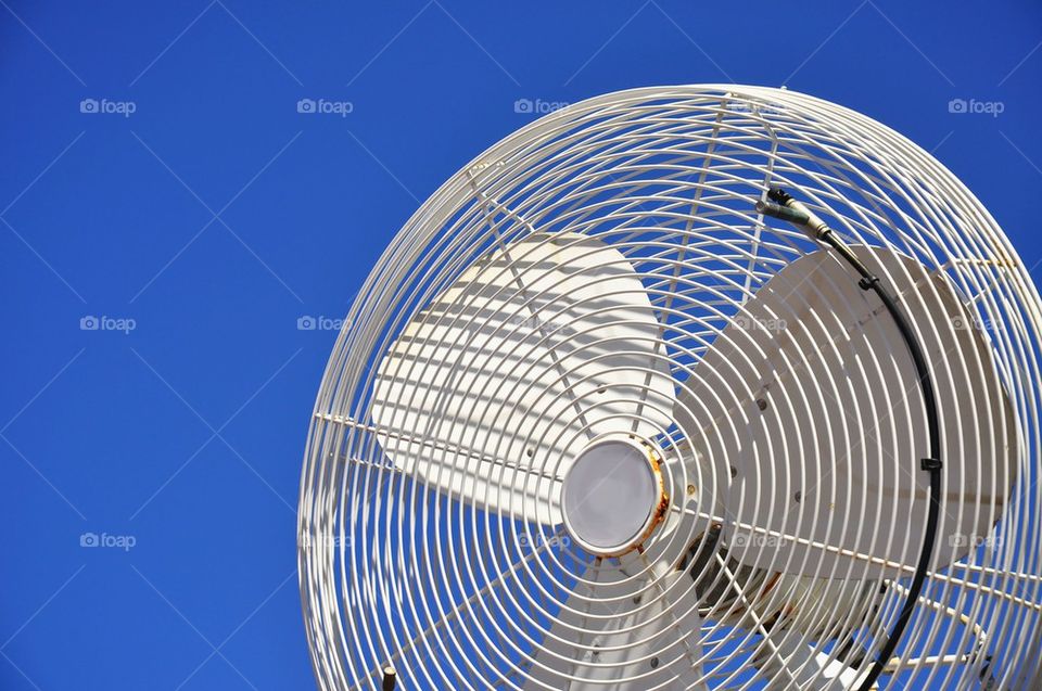 White fan against a blue sky