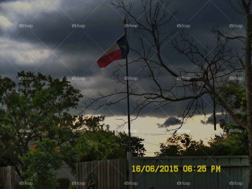 dark clouds 3. this is a picture of our Texas flag  with a cloudy background