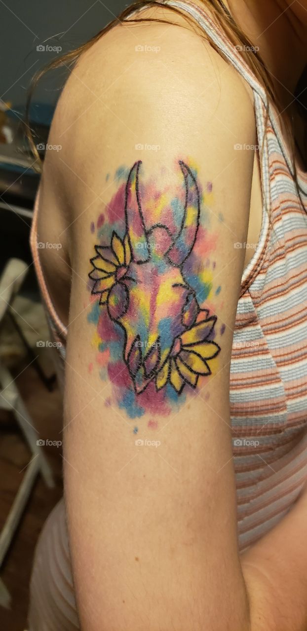 Got skull watercolor tattoo with black lines skull and pink, blue, yellow and magenta splashes