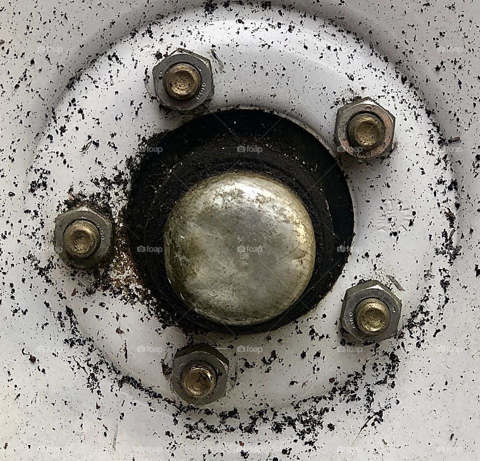 Closeup of tire rim and nuts 