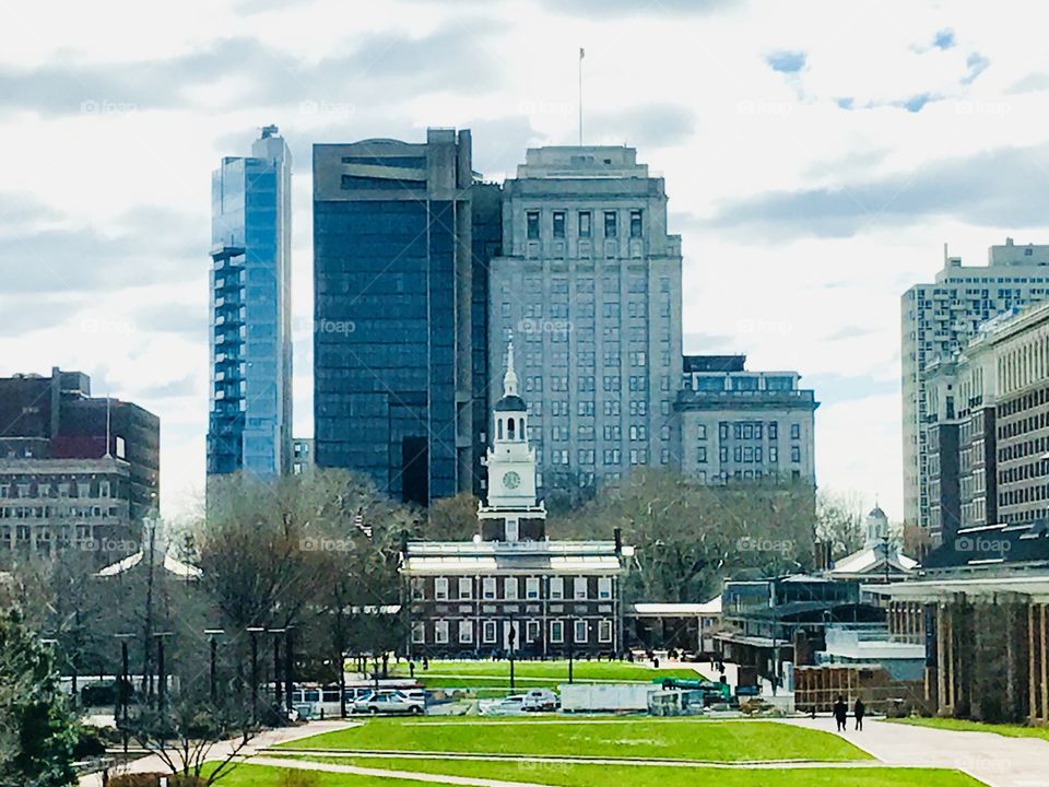 Beautiful view of historic Independence Mall with Independence Hall in Philadelphia. Large modern skyscrapers in the background.