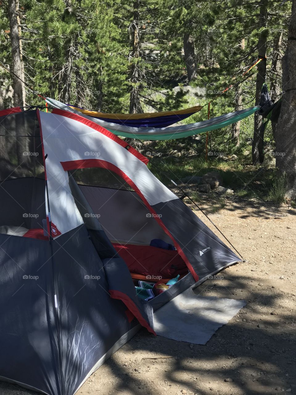 The perfect set up to a perfect day of camping. A tent ready and waiting for its inhabitants and hammocks aligned for relaxation in the meantime. 