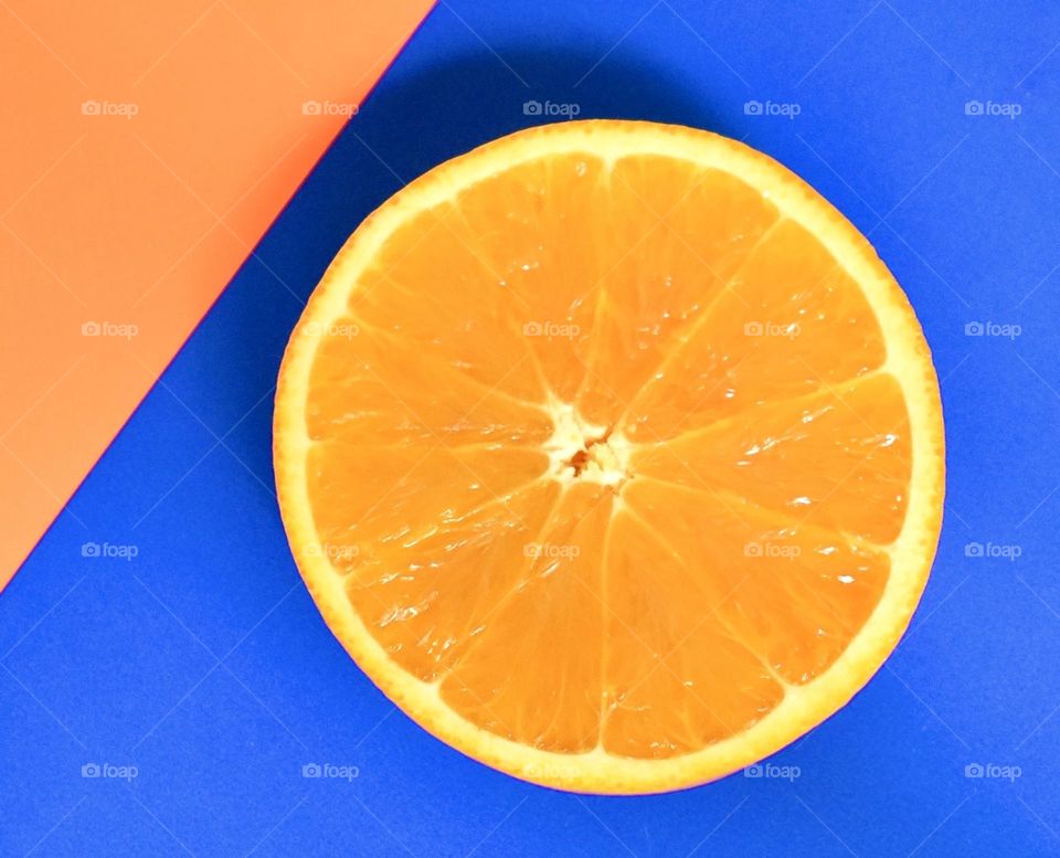 Minimalism orange slice on blue 