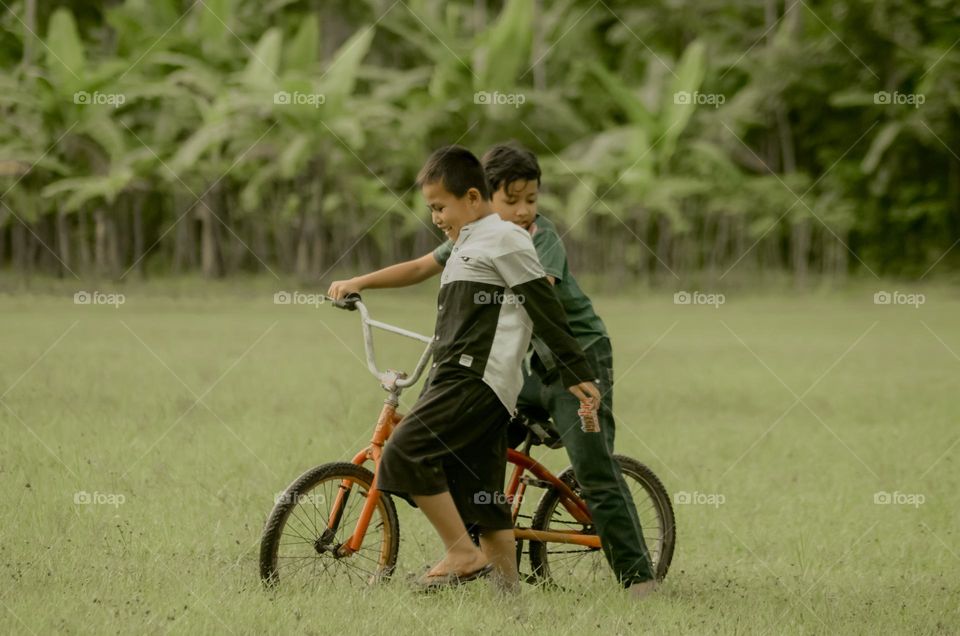 two small children playing in the field