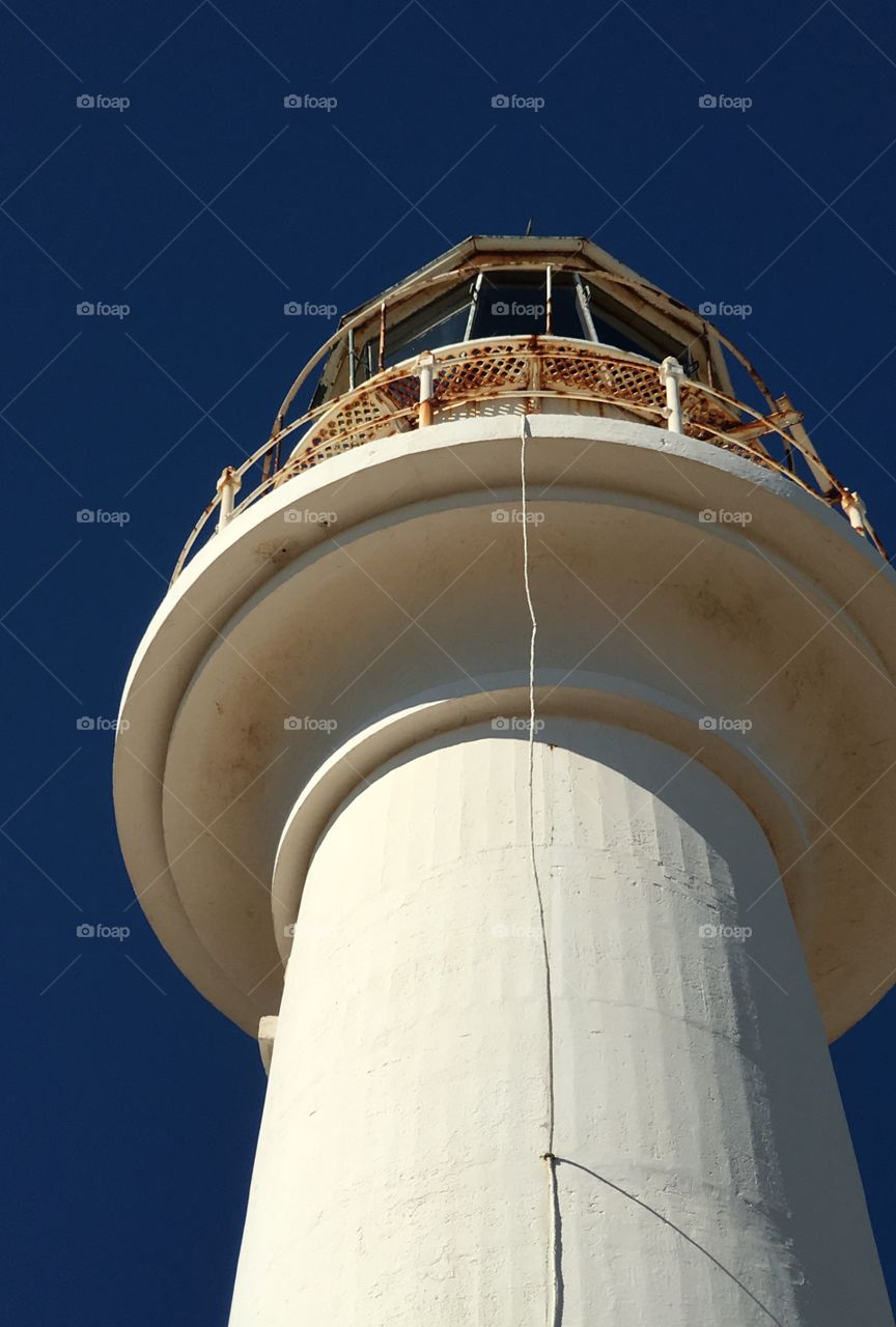 From the ground up perspective of top of old stone white lighthouse, Point Lowly, South Australia 