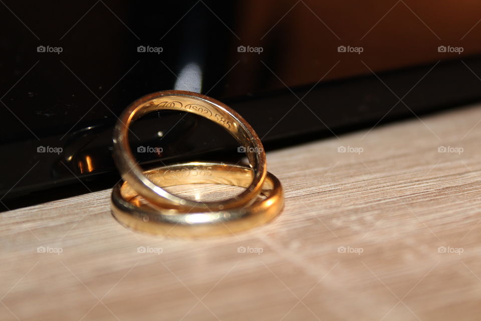 wedding rings on a wooden table close-up
