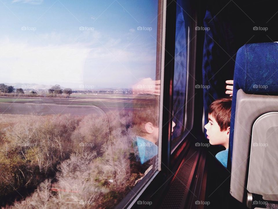 Boy looking out train window