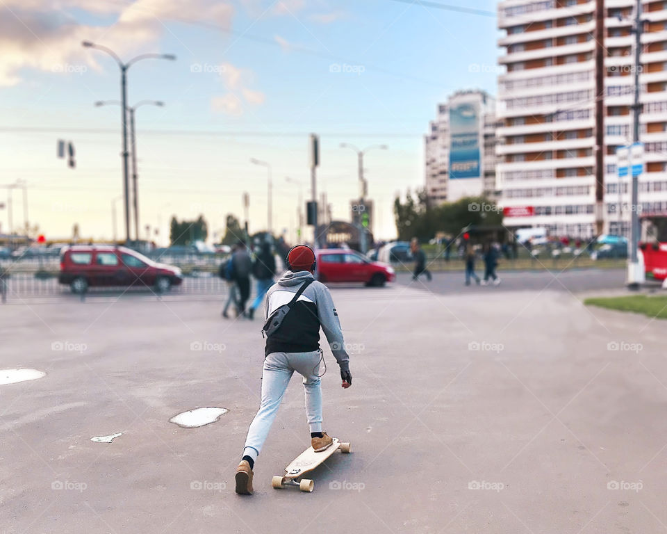 Listening to the music while skateboarding through the city 