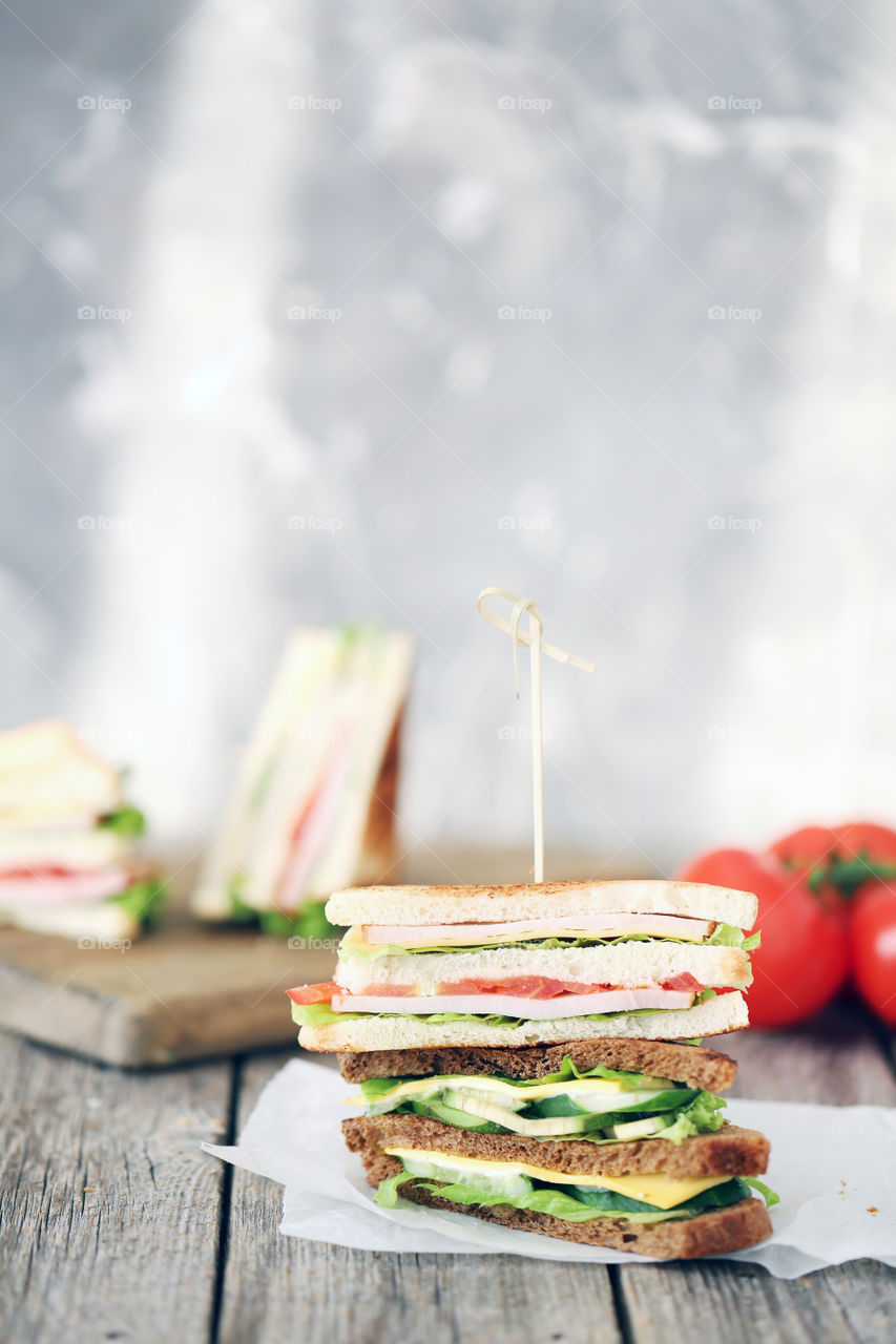 Tasty sandwiches on grey background. Delicious food