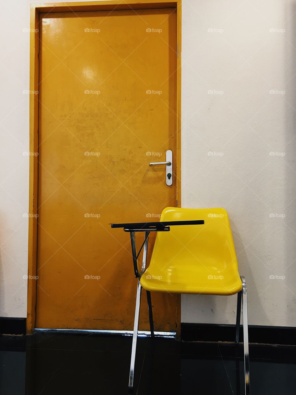 Yellow chair and brown door as background