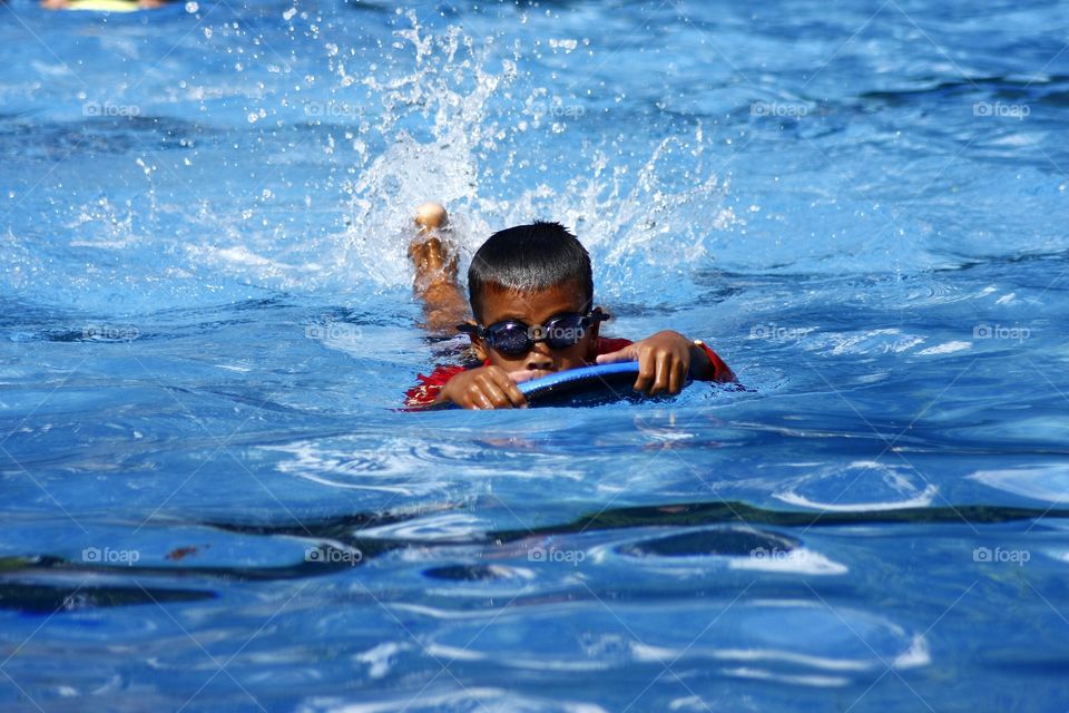 young kid in a swimming pool