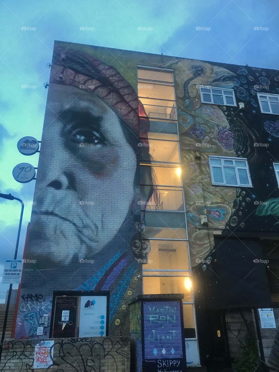 London, UK.  A graffiti artist’s large-scale rendition of an Apache on an apartment building.