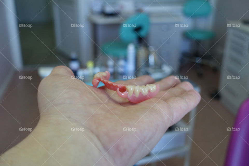 Dentures in hand