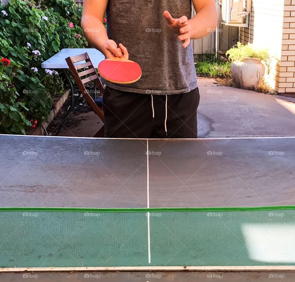 Table tennis ping pong anyone? Outdoor table one player facing with paddle