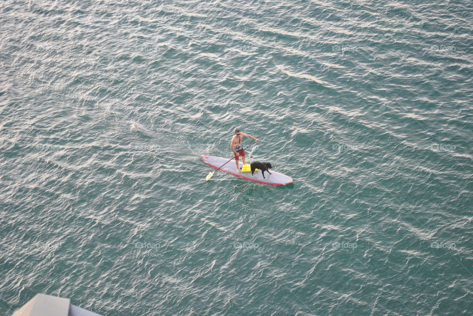 A guy on a paddle board in the water