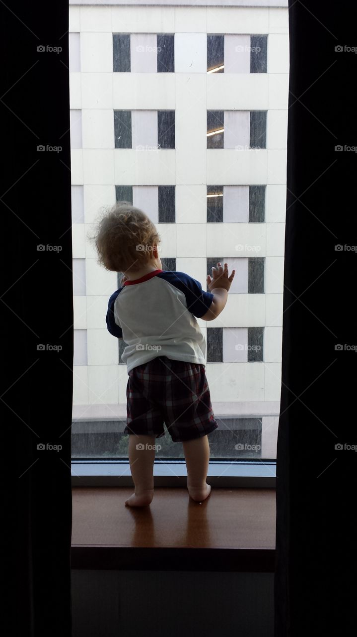 curious baby. Watching a garbage truck from a San Diego hotel window. 